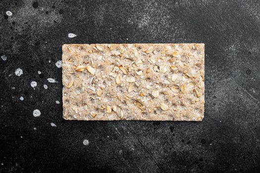 Crunchy crispbread Healthy snack, on black dark stone table background, top view flat lay