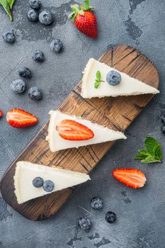 Classic New York Cheesecake sliced, on gray background, top view flat lay