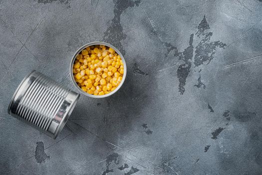 Canned sweet corn, on gray background, top view flat lay with copy space for text