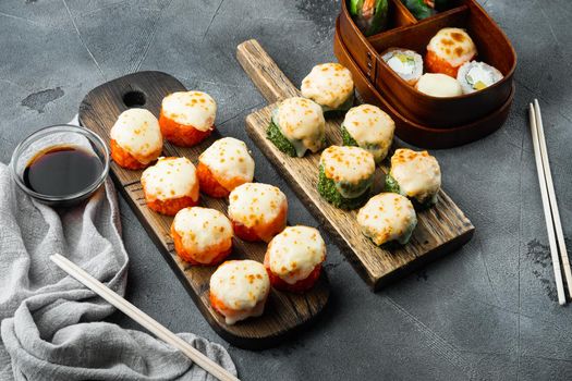 Japanese sushi rolls named Baked Ebi with wasabi and salmon fish, on gray stone background