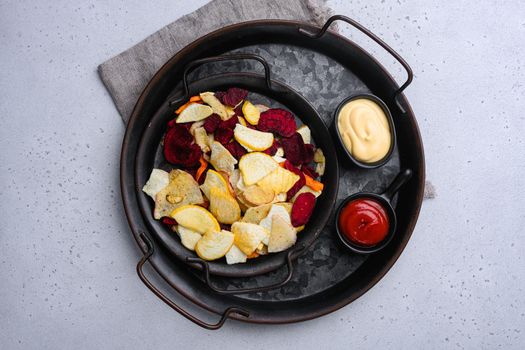 Root Vegetable Crisps, on gray stone table background, top view flat lay, with copy space for text