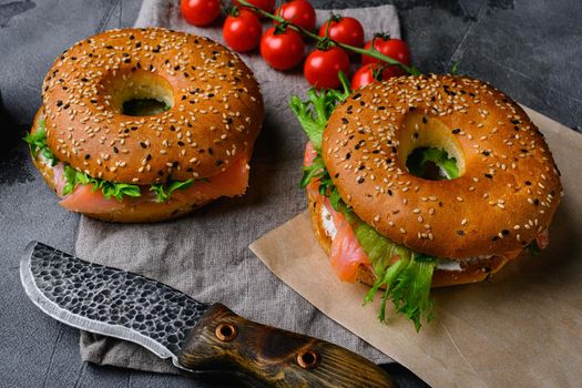 Traditional bagel with salmon and cream cheese, on gray stone table background