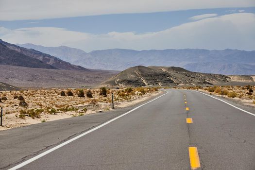 Road through Death Valley surrounded by sandy desert