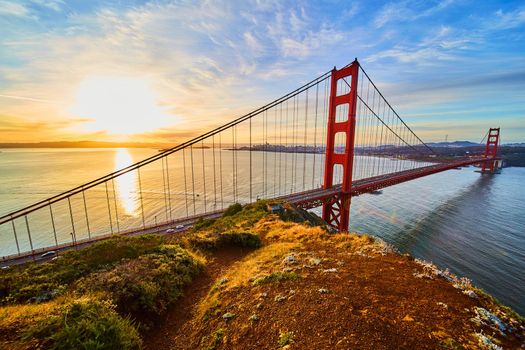 Path on cliffs overlooking Golden Gate Bridge at sunrise from northwest