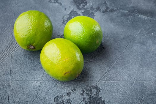 Ripe green lime, on gray background with copy space for text