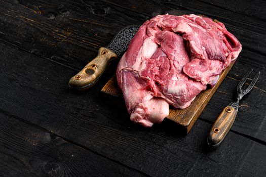 Raw lamb fillet Fresh organic meat, on black wooden table background, with copy space for text