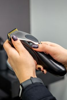 Hair clipper in hands of female