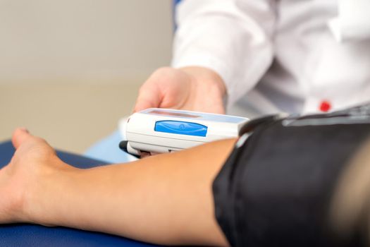 Nurse measuring arterial blood pressure