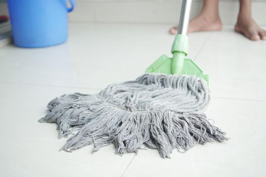 cleaning tiles floor with mop