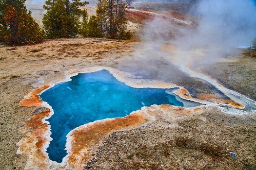 Small crystal clear blue spring at Yellowstone National Park
