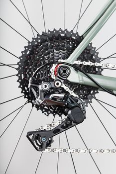 Black bicycle 11-speed cassette with switch and chain close-up, accessories for bike repair and tuning