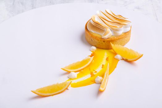 Appetizing lemon tartlets with meringue served on a white plate