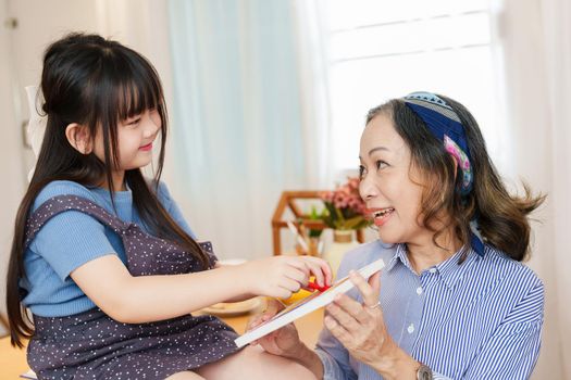 Asian portrait, grandchild granddaughter grandma grandmother and granddaughter happily join in activities to enhance skills for grandchildren