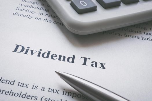 Dividend tax information page, calculator and pen.