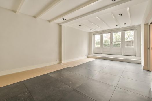 Empty room with white walls and tiled floor