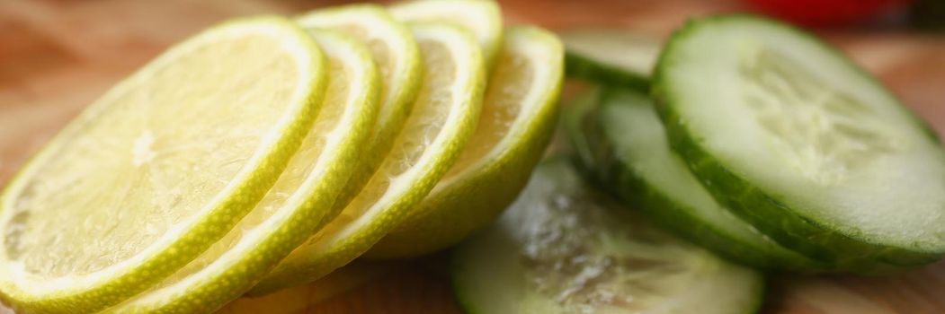 Fresh sliced cucumber and citrus lemon for further cooking