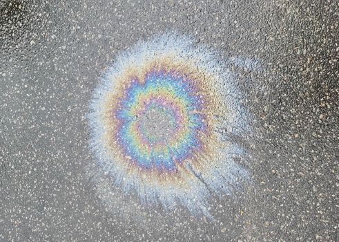 The color diluted with gasoline in a puddle. environmental pollution