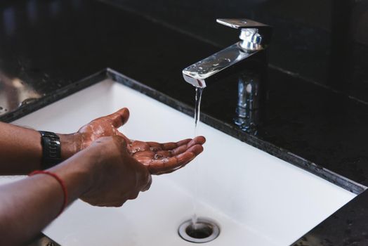 man hands rubbing with soap and water in sinks