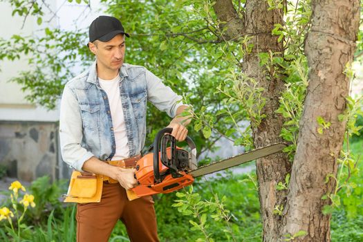 Man cutting a branch with chainsaw
