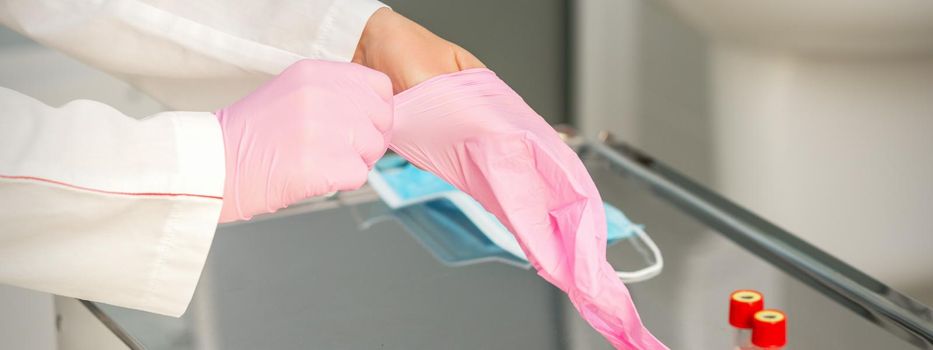 Doctor wearing rubber protective gloves