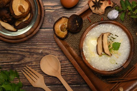 Rice porridge with soft boiled egg, shiitake mushroom, slice ginger and slice scallion for light meal