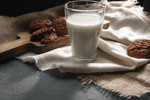Glass of milk and cookies on table