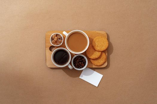 Top view of the wooden tray with coffee cup on beige background