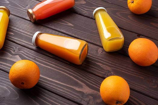 Fresh orange juice in the glass with orange fruit on wooden background