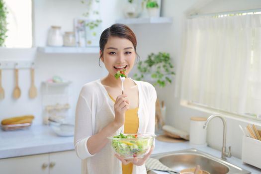 woman is eating a salat in bowl, indoor