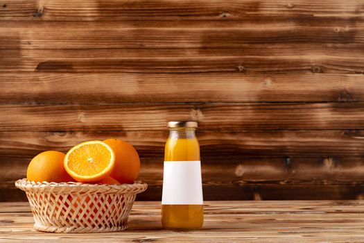 Orange fruit and orange juice on wooden background