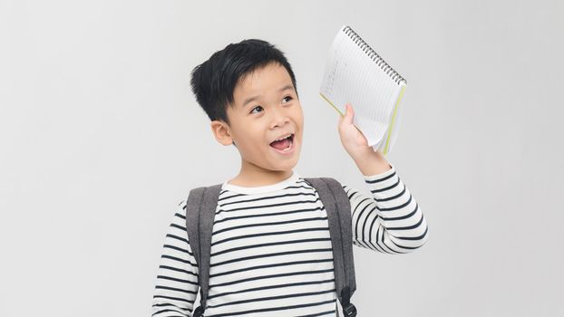 School boy reading a book - isolated over a white background