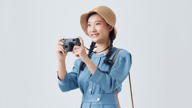 Beautiful smiling asian woman with photo camera