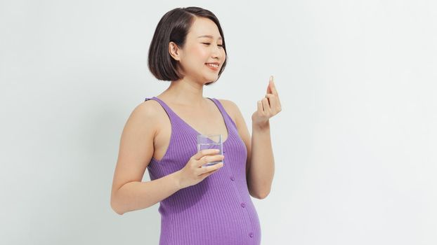 Pregnant woman with fish oil at home