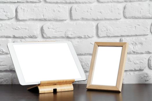 Mockup creative workspace with blank screen tablet and photo frame
