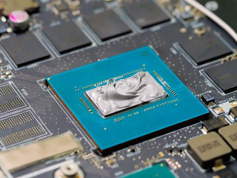 Graphics processor on the motherboard of a laptop with thermal paste.