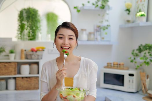 Beautiful young girl with a plate of fresh vitamin salad from vegetables
