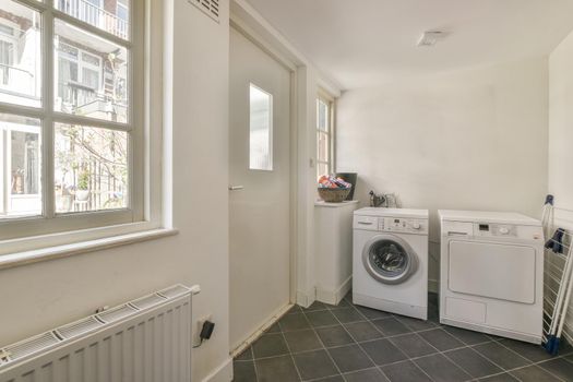 Spacious bright room with washing machine and dryer