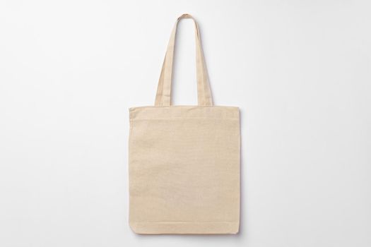 Empty fabric shopping bag on white background