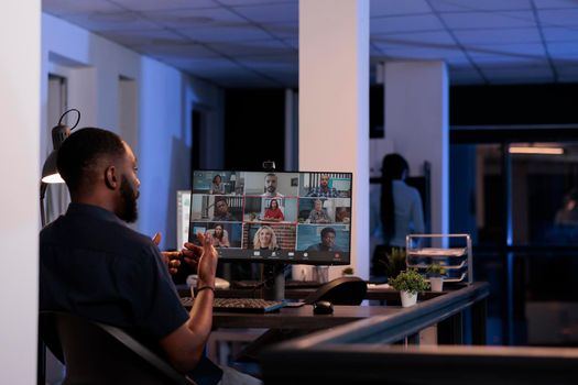 African american man talking to coworkers on remote videoconference call