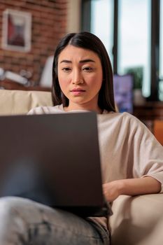 Authentic asian young woman using laptop computer