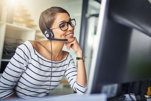 Offering reliable customer support. Cropped shot of a young attractive female customer support agent working in the office.