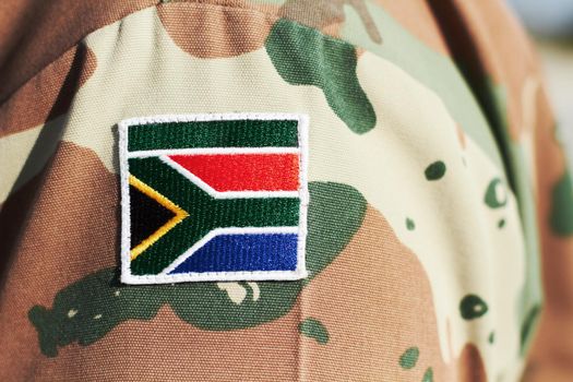 Proud fighting man. Cropped closeup shot of a South African flag on a soldiers uniform.