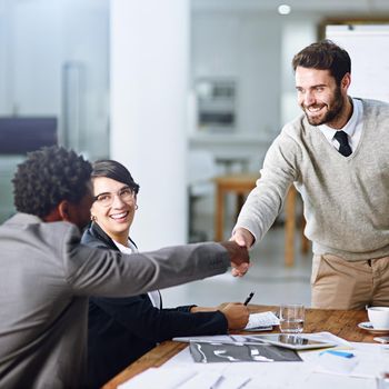 Welcoming another exceptional member to the team. Cropped shot of businesspeople shaking hands during a meeting in an office.