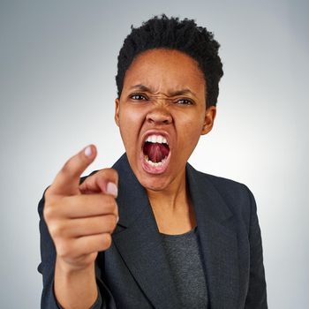 How many more times do I need to warn you. Portrait of a furious businesswoman yelling and pointing in anger.