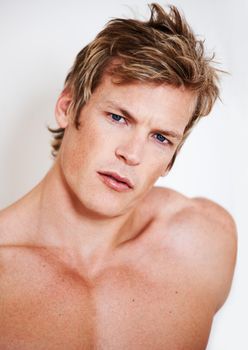 Hunky and handsome. Portrait of a muscular young man posing in studio.