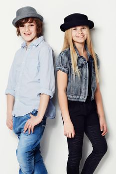 Cool kids. Portrait of two fashionable young kids posing in the studio.