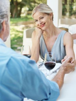 Hes still her dream guy. Happy mature couple toasting their love with two glasses of wine while outdoors.