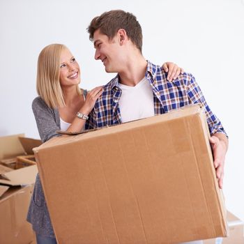 So glad we finally moved into our new home. Shot of a happy young couple on their moving in day.