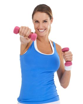 Toning her arms. Fit young woman smiling while using dumbbells against a white background.