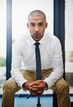 Young and goal-orientated. Portrait of a determined looking businessman sitting in the office.